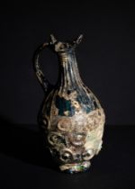 AN AYYUBID DEEP SEA BLUE GLASS JUG, SYRIA OR EGYPT, 13TH CENTURY