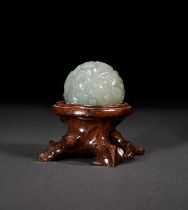 A CELADON JADE BALL FORM INCENSE STICK HOLDER, QING DYNASTY (1644-1911)