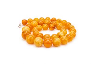 A LARGE STRAND OF AMBER BEADS