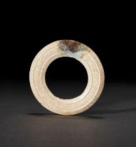 A CHICKEN BONE JADE RING (HUAN). SPRING & AUTUMN, WARRING STATES PERIOD