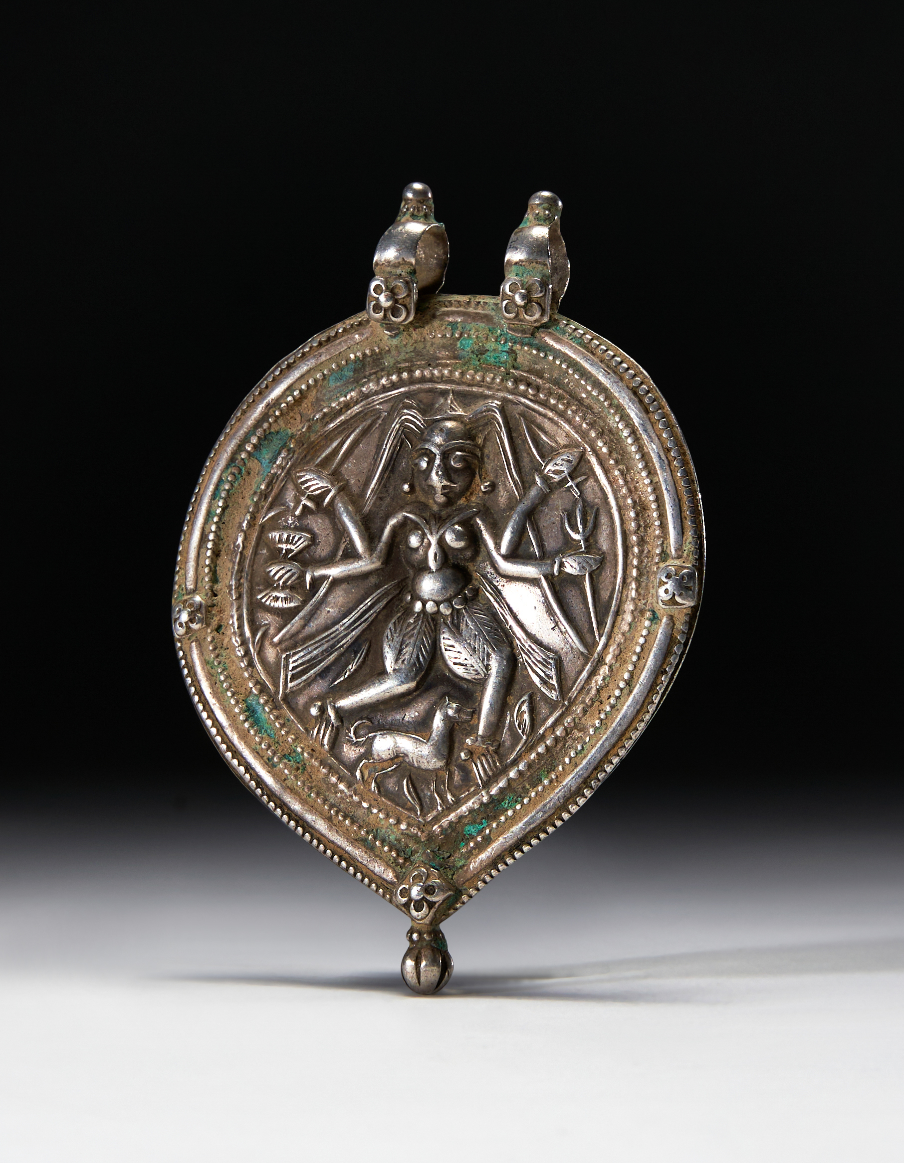 A SILVER AMULET OF SHIVA, NORTHERN INDIA, 19TH/20TH CENTURY
