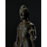 A LARGE BRONZE STANDING BUDDHA