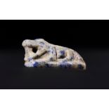 AN EGYPTIAN RECUMBENT CROCADILE LAPIS LAZULI AMULET PTOLEMAIC PERIOD, CIRCA 332-30 B.C.