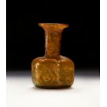 A ROMAN YELLOW GLASS JEWISH MENORAH BOTTLE , CIRCA 3RD CENTURY A.D.