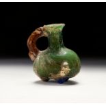 A POST SASANIAN COLOURFUL GLASS BOTTLE WITH HANDLE, CIRCA 5TH CENTURY A.D.
