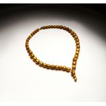 A GOLD FOILED NECKLACE, PROBABLY ROMAN