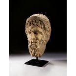 A LARGE CARVED STONE BUST OF A BEARDED MAN, CIRCA 3RD CENTURY A.D. OR LATER