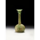 A POST SASANIAN GREEN GLASS BOTTLE, CIRCA 5TH CENTURY A.D.