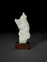 A CHINESE WHITE JADE CARVING OF AN IMMORTAL ON A HONGMU WOODEN BASE, QING DYNASTY (1644-1911)