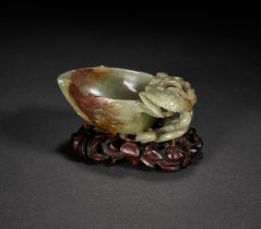 A CHINESE CARVED DARK CELADON AND RUSSET JADE BRUSH WASHER, MING DYNASTY (1368-1644)