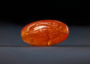 A VERY RARE CARNELIAN MINOAN DOLPHIN SEA CREATURES SEAL, LATE PALACE PERIOD, CIRCA 16TH CENTURY B.C.