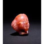 A RARE ROMAN RED CHALCYDONLY HEAD OF THE EMPRESS APOLLO, CIRCA 1ST-2ND CENTURY A.D.