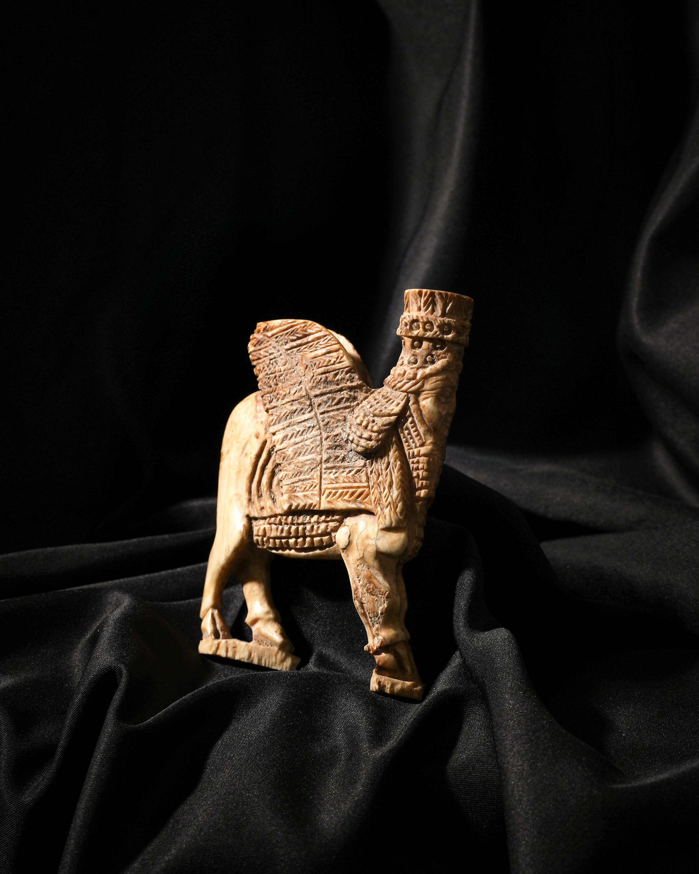 AN ACHAEMENID CARVED APPLIQUE OF A LAMASSU IRAN, REIGN OF ARTAXERXES II, 404-359 B.C.