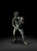 A GRAND TOUR BRONZE OF A YOUNG SATYR WITH A WINESKIN, 18TH CENTURY