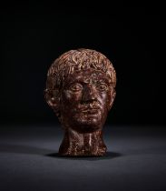 A GREEK GRANITE HEAD OF A ATHLETE, CIRCA 5TH CENTURY A.D.