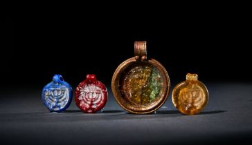 FOUR ROMAN GLASS MENORAH PENDANTS, CIRCA 1ST CENTURY A.D.