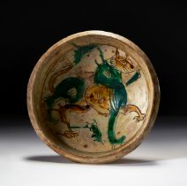 A RARE THREE COLOURED GLAZED "FELINE" BOWL, CYPRUS, 12TH CENTURY