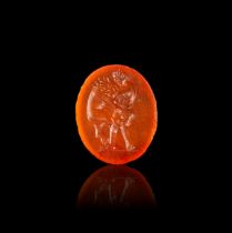 A ROMAN CARNELIAN INTAGLIO OF AN ATHLETE WRESTLING A LION, CIRCA 1ST-2ND CENTURY A.D.