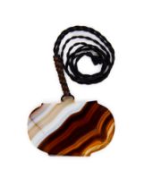 A LARGE BANDED AGATE AMULET