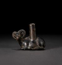 A BRONZE FIGURE OF A SEATED IBEX, CHINESE OR GREEK