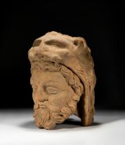 A TERRACOTTA HEAD OF A BEARDED WARRIOR