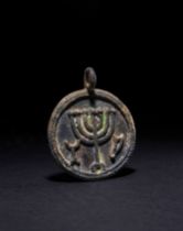 A BRONZE MENORAH PENDANT, ROMAN, 1ST CENTURY A.D.