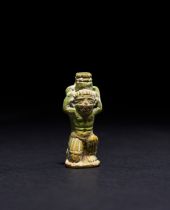 A MINIATURE AMULET OF A SQUATTING MAN, EGYPTIAN OR PRE COLUMBIAN