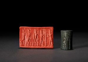 A SUMERIAN BLACK STONE CYLINDER SEAL THIRD DYNASTY OF UR, CIRCA 2112-2004 B.C.