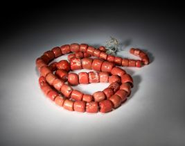 A LARGE STRAND OF PINK CORAL BEADS