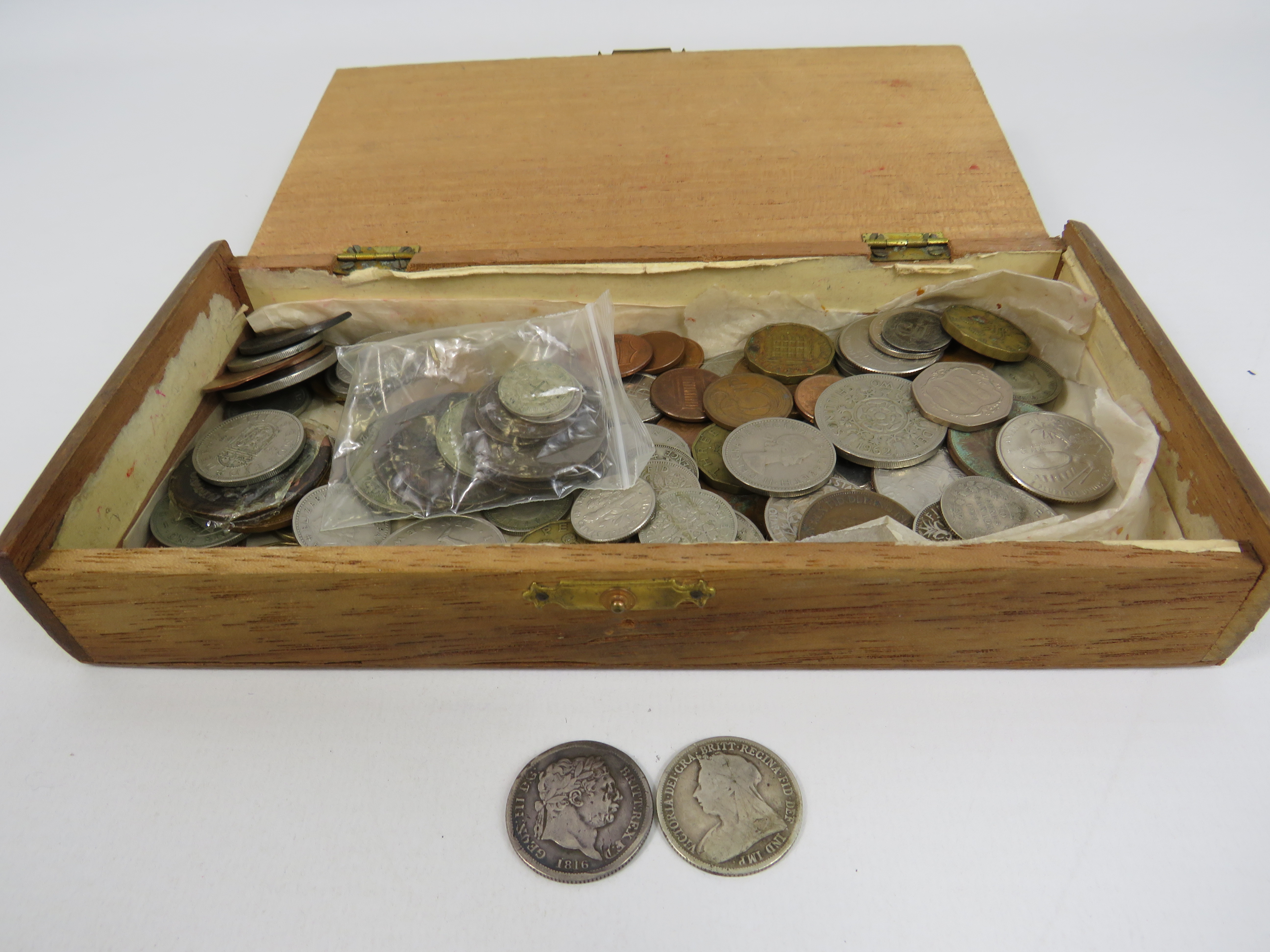 Wooden box containing various coins including a 1816 George III Shilling.