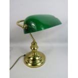 Brass banker lamp with green glass shade.