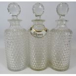 3 Matching crystal glass decanters and a Limoges ceramic decanter label. approx 28cm tall.