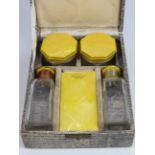 Art Deco travel bottle set with yellow lustre Lucite tops.