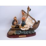 Resin sculpture of a boat and fishermen. Aprrox 28cm tall and 34cm long.