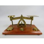 Set of brass postoffice scales with weights.