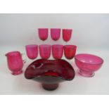 Selection of vintage cranberry glass and a red art glass bowl.