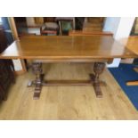 Mid Oak Refectory style table raised on twin turned and carved pillars