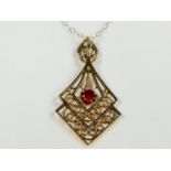 Double lozenge shaped pendant set with a solitaire Ruby