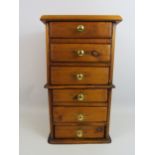 Wooden Table top chest with 6 drawers and brass handles, approx 18" tall, 8.5" deep and 10" wide