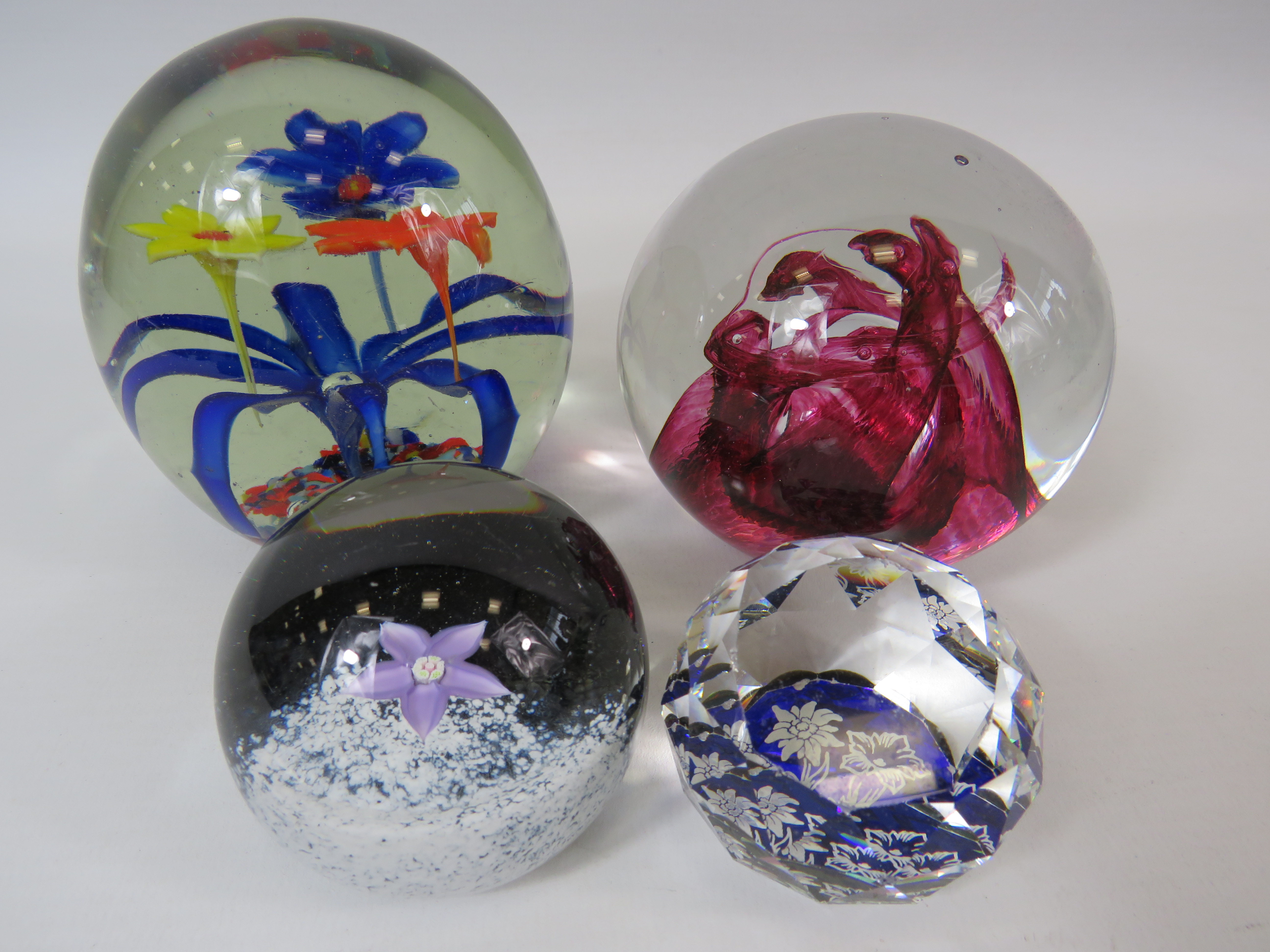 4 art glass paperweights including Caithness.