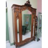 Large imposing mirror fronted wardrobe with carved details and pediment. Approx 8ft tall. 55 inches