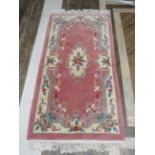 Oriental style fringed woolen rug which measures 72 x 37 inches in good clean condition. See photos.