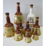 9 Empty bells whiskey decanters various sizes.