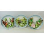 Three pretty 3D Ceramic Bird plates with wire wall hangers. See photos.