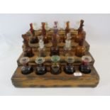 Wooden waterfall stand containing 20 vintage Apocathary bottles.