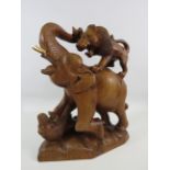 Wooden carved figurine of Lions attacking a elephant approx 13" tall.