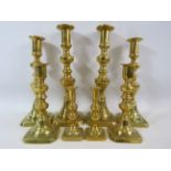 4 Pairs of brass candle sticks graduated in size the tallest measure 9.5" tall.