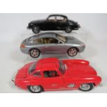 Three 1:18 Scale Die cast models of 1954 Mercedes 500Sl by Burago, Porsche 911 by unknown maker, Dai