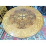 Large and lovely tilt top circular table with stunning inlaid marquetry patterns. Standing on carved