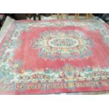 Beautiful wool rug of room size, fringed and decorated with flower pattern. Measures 141 x 105 inch
